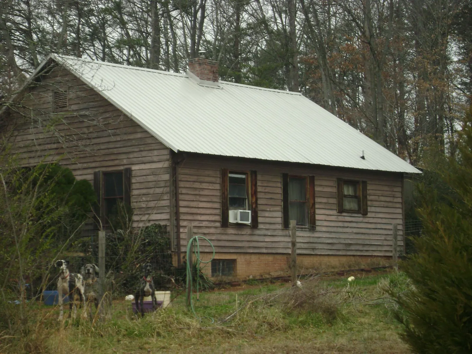 White metal roof on an old wood sided farmhouse, from a Metal Roof Installation job in Stewartville